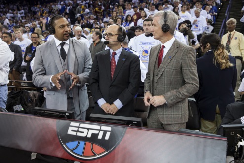 ESPN Commentators stand courtside with microphones discussing NBA game