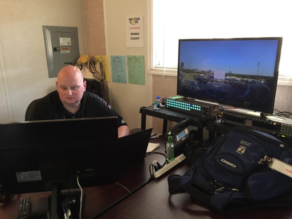 Dennis Cleary sits in am ESPN remote editing bay