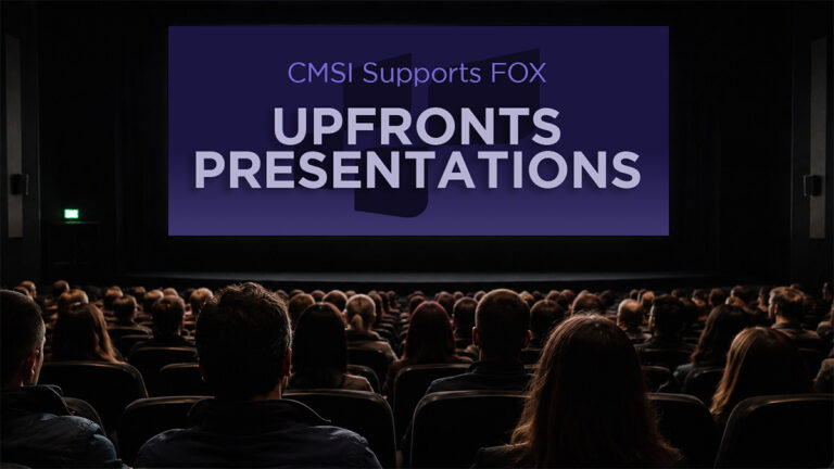"CMSI Supports FOX Upfronts Presentations" words on a large movie theatre screen with a large audience facing the screen