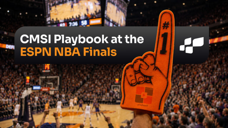 Foam finger with CMSI Playbook logo in front of a giant basketball stadium crowd